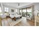 Bright bedroom with balcony, and light-colored wood floors and decor at 224 Chilson Ave, Anna Maria, FL 34216