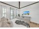 Cozy bedroom with a beamed ceiling, a relaxing atmosphere, and balcony access with natural light at 224 Chilson Ave, Anna Maria, FL 34216