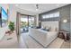 Modern bedroom featuring a king bed, an accent wall, and sliding glass doors to a balcony at 224 Chilson Ave, Anna Maria, FL 34216