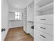 Spacious walk-in closet featuring custom shelving, and storage drawers at 224 Chilson Ave, Anna Maria, FL 34216