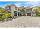 Grand home with a spacious driveway, three-car garage, and manicured landscaping at 224 Chilson Ave, Anna Maria, FL 34216