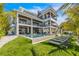 Expansive backyard featuring a pool, lounge chairs, and a modern three-story home at 224 Chilson Ave, Anna Maria, FL 34216