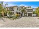 Stunning two-story home with private balconies, lush tropical landscaping, and a beautiful paved driveway at 224 Chilson Ave, Anna Maria, FL 34216