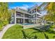 Expansive backyard featuring a pool, lounge chairs, and a modern three-story home at 224 Chilson Ave, Anna Maria, FL 34216