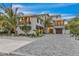 Elegant facade of home featuring a brick driveway, two-story design, and lush landscaping at 224 Chilson Ave, Anna Maria, FL 34216