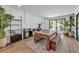 Spacious game room with stylish decor, statement rug, and seamless indoor-outdoor flow at 224 Chilson Ave, Anna Maria, FL 34216