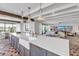 Spacious kitchen island with a white countertop, a farmhouse sink, and seating for four, with an open-concept design at 224 Chilson Ave, Anna Maria, FL 34216