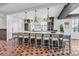 Open kitchen features a large island with seating and modern pendant lighting at 224 Chilson Ave, Anna Maria, FL 34216