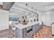 Bright, open kitchen with a large island, stainless steel appliances, and a view into the living room at 224 Chilson Ave, Anna Maria, FL 34216