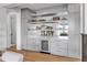 Chic bar and living area featuring custom cabinets, shelving and a beverage refrigerator at 224 Chilson Ave, Anna Maria, FL 34216