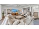 Bright, open-concept living area with stylish furniture, a large TV, and ample natural light at 224 Chilson Ave, Anna Maria, FL 34216