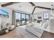 Bright main bedroom with beamed ceilings, balcony, and large windows offering scenic views at 224 Chilson Ave, Anna Maria, FL 34216