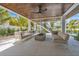 Inviting outdoor living area with comfortable seating, a modern fire pit, and a covered patio with wood ceiling at 224 Chilson Ave, Anna Maria, FL 34216