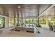Expansive covered patio with stylish seating, a fountain feature, and tranquil views at 224 Chilson Ave, Anna Maria, FL 34216