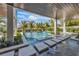 Beautiful outdoor living space with a pool and stepping stones surrounded by tropical landscaping and lush greenery at 224 Chilson Ave, Anna Maria, FL 34216