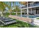 Stunning pool area with lounge chairs, lush landscaping, and modern architectural details at 224 Chilson Ave, Anna Maria, FL 34216