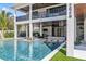 Luxurious pool with swim up bar, stone steps, and outdoor seating area underneath the covered porch at 224 Chilson Ave, Anna Maria, FL 34216