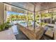 Inviting outdoor area featuring a luxurious pool with tropical landscaping and covered dining area at 224 Chilson Ave, Anna Maria, FL 34216