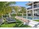 A luxurious pool surrounded by lush landscaping and comfortable lounge chairs at 224 Chilson Ave, Anna Maria, FL 34216