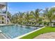 Inviting pool with lounge chairs, palm trees, and serene water views at 224 Chilson Ave, Anna Maria, FL 34216