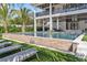 Beautiful backyard pool with an outdoor bar and lounging area for relaxation at 224 Chilson Ave, Anna Maria, FL 34216