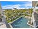 Aerial view of a backyard pool surrounded by palm trees and lounge chairs at 224 Chilson Ave, Anna Maria, FL 34216