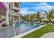 Stunning infinity pool view with lush landscaping and elegant lounge seating, offering a serene oasis at 224 Chilson Ave, Anna Maria, FL 34216