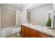 Bathroom featuring a double vanity, a mirror, and a bathtub with a shower at 25364 Tether Ln, Punta Gorda, FL 33983