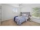 Cozy bedroom with patterned bedding, and natural light from a large window at 25364 Tether Ln, Punta Gorda, FL 33983