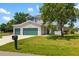 Charming two-story home with three-car garage, lush landscaping, and mature shade trees at 25364 Tether Ln, Punta Gorda, FL 33983