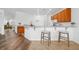 Kitchen with a breakfast bar and two modern stools on tile flooring at 25364 Tether Ln, Punta Gorda, FL 33983