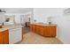 Kitchen with a breakfast bar, featuring wooden cabinets and tile flooring at 25364 Tether Ln, Punta Gorda, FL 33983