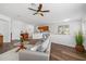 Open-concept living area with wood floors, a view of the kitchen, and a comfortable seating area at 25364 Tether Ln, Punta Gorda, FL 33983