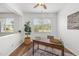 Bright and modern office with wood desk, rug, and plenty of natural light at 25364 Tether Ln, Punta Gorda, FL 33983