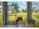 Enclosed patio area with peaceful backyard views and comfortable seating area at 25364 Tether Ln, Punta Gorda, FL 33983