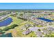 Picturesque aerial view of a golf course community with lush landscaping and numerous ponds at 302 Crystal Downs Ct, Sun City Center, FL 33573