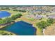 Aerial view of the residence showcasing the surrounding lakes, golf course, and community landscape at 302 Crystal Downs Ct, Sun City Center, FL 33573