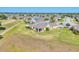 Wide aerial shot showcasing the property's location within a community, nestled near a lake, golf course, and residences at 302 Crystal Downs Ct, Sun City Center, FL 33573