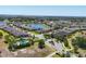 Sun City Center neighborhood aerial view with a community pool, gate, pond, and beautiful landscaping at 302 Crystal Downs Ct, Sun City Center, FL 33573