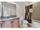 Bathroom featuring a vanity, toilet, and a shower with decorative shower curtain at 302 Crystal Downs Ct, Sun City Center, FL 33573