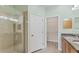Bathroom featuring a walk-in shower and door leading to the closet at 302 Crystal Downs Ct, Sun City Center, FL 33573