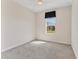 Neutral-toned bedroom featuring a window with blind at 302 Crystal Downs Ct, Sun City Center, FL 33573