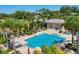 Sun City Center community pool, with lounge chairs and tropical landscaping for a resort-like experience at 302 Crystal Downs Ct, Sun City Center, FL 33573