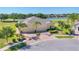 Stunning single-story home featuring lush landscaping, a brick driveway, and a three-car garage at 302 Crystal Downs Ct, Sun City Center, FL 33573