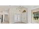Bright foyer features high ceilings, transom windows, and views into other rooms at 302 Crystal Downs Ct, Sun City Center, FL 33573