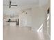 Open living room showcases tile floors, kitchen view, and seamless flow to other spaces in home at 302 Crystal Downs Ct, Sun City Center, FL 33573