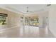 Bright living room with tile floors, ceiling fan, and sliding glass doors to the screened lanai at 302 Crystal Downs Ct, Sun City Center, FL 33573