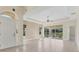 Open-concept living area featuring neutral colors, tile flooring, and sliding glass doors at 302 Crystal Downs Ct, Sun City Center, FL 33573