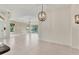Open floor plan living room with large windows providing natural light and beautiful backyard views at 302 Crystal Downs Ct, Sun City Center, FL 33573
