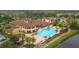 A beautiful community pool area with a clubhouse and lush landscaping and a golf green at 302 Crystal Downs Ct, Sun City Center, FL 33573